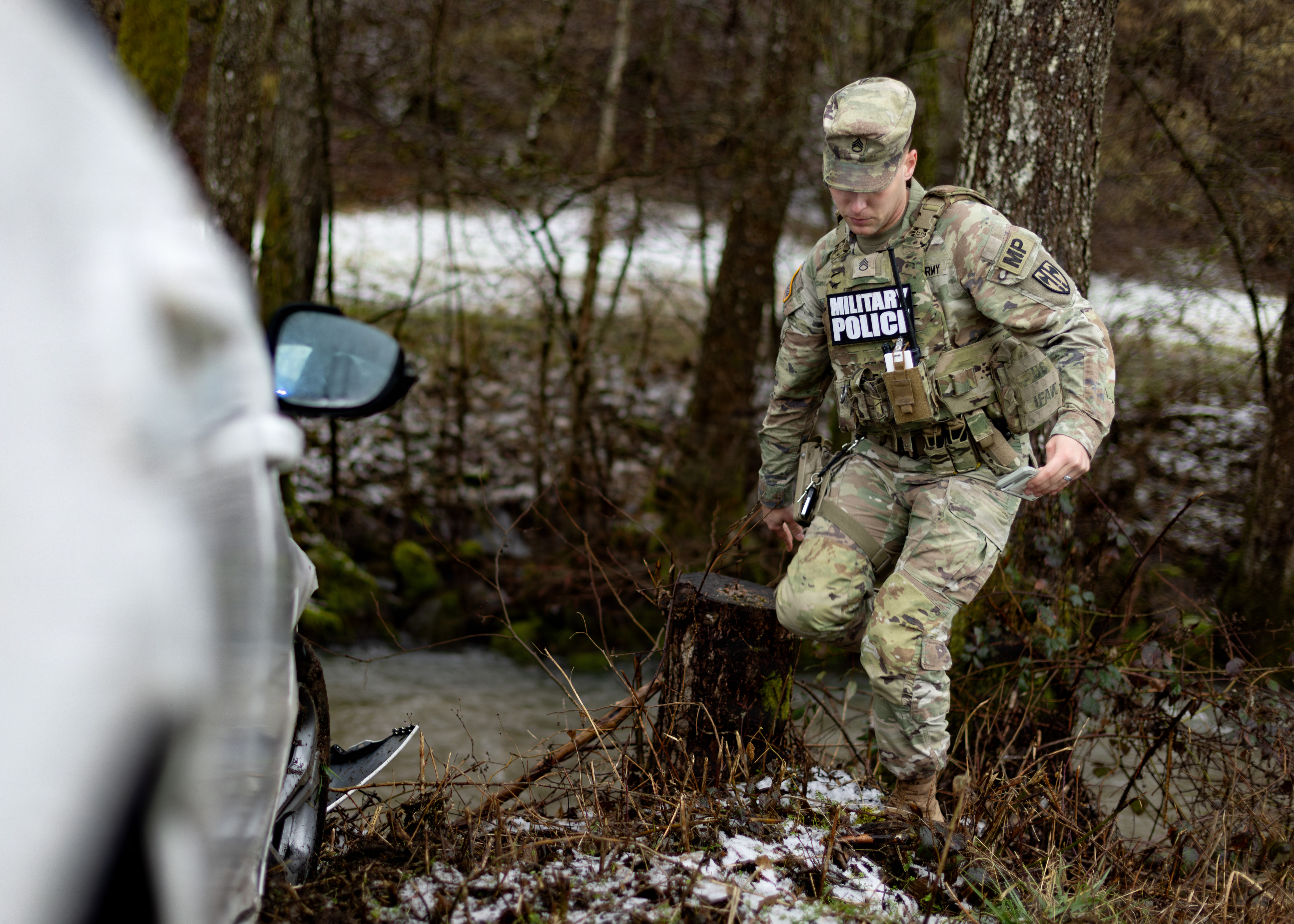 U.S. Army Staff Sgt. Cameron Corey, a military police officer assigned to the 92nd Military Police Company, 709th Military Police Battalion, 18th Military Police Brigade, documents a traffic accident scene in Baumholder, Germany, Feb. 19, 2026. The documentation supports official reporting and inves