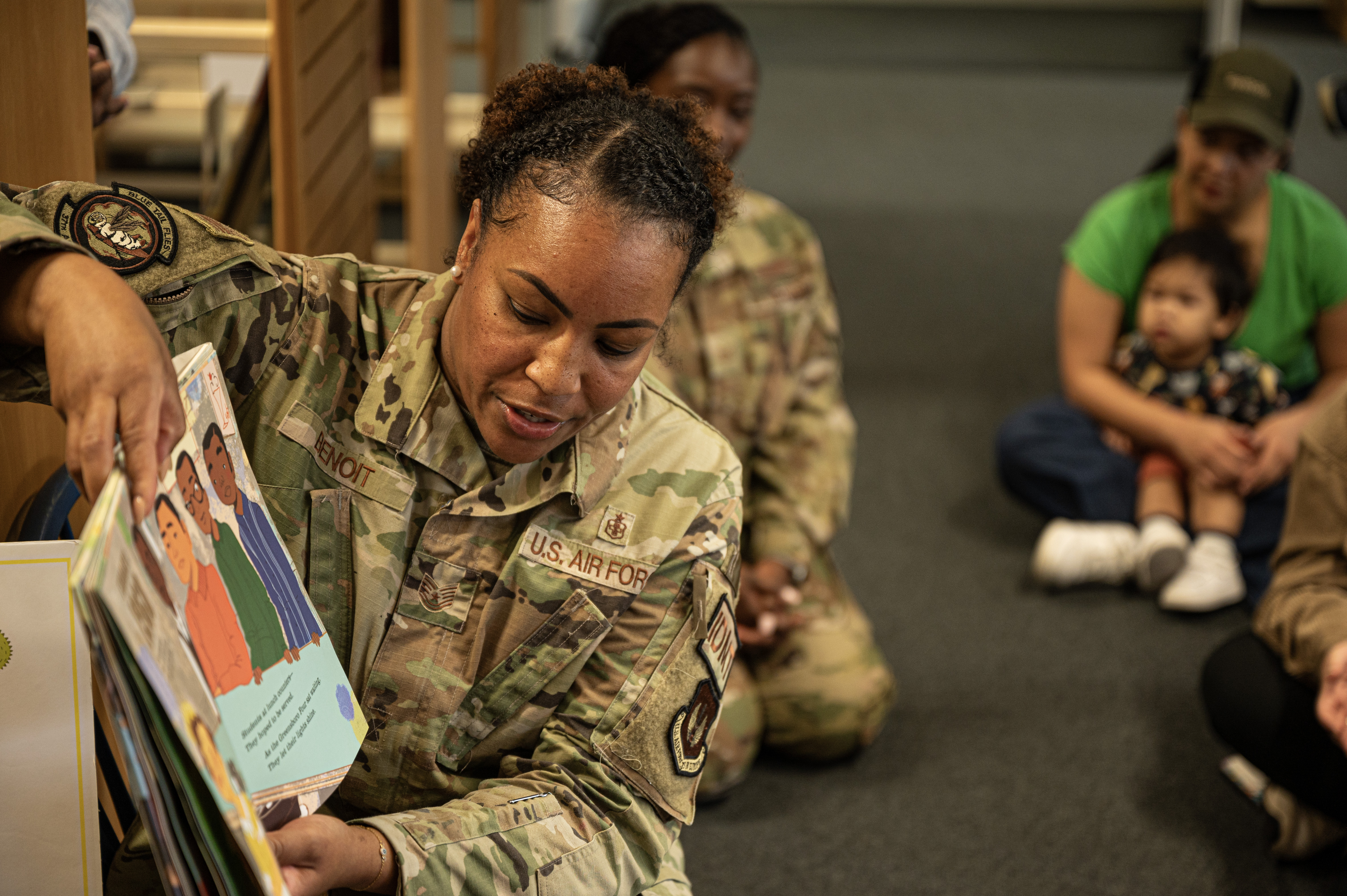 U.S. Air Force Tech. Sgt. Aquarius Benoit, 37th Airlift Squadron independent duty medical technician, reads to children during a Juneteenth book reading at Ramstein Air Base, Germany, June 20, 2024. Juneteenth is a holiday marking the day when Union Maj. Gen. Gordon Granger rode into Galveston, Texa